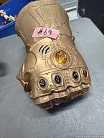 Top view of gold plastic Infinity Gauntlet with stones visible