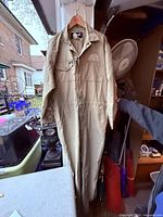 Front view of khaki Hammill coverall hanging, showing overall style and condition