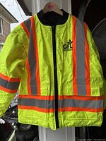Front view of neon yellow hi-vis jacket with reflective stripes and GFL logo