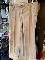 Front view of khaki Tommy Hilfiger pants hanging