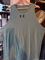 Front view of green Under Armour fitted tank top with logo