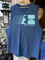 Front view of blue Under Armour HeatGear tank top showing logo graphic