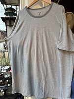 Front view of grey Under Armour T-shirt on hanger