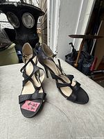 Top view of both sandals showing black strappy design and size label
