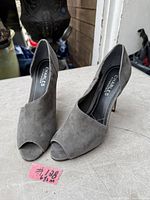 Front and side view of grey suede high heel shoes standing together