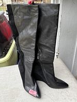 Full view of both boots standing upright showing leather and suede panels