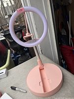 Ring light assembled on stand showing base, pole, phone clamp and controls