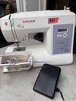 Front view of Singer 6160 sewing machine with foot pedal attached
