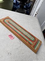 Top view of cribbage board showing painted track and wood surface