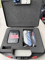 TENS 3000 unit, lead wires, electrode pads in foam-lined carrying case