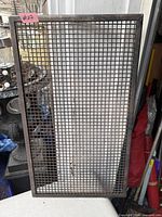 Full view of rectangular iron wire mesh screen leaning vertically