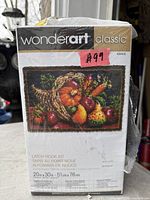 Front of Wonderart Classic latch hook kit box showing fruit basket design and size 20 x 30 in