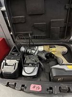 Drill, batteries, charger and case inside open case