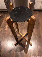 Wood stand with black circular mounting plate