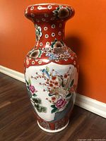 full view of vase front showing bird and floral panel