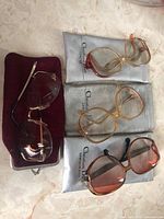 All three eyewear pairs with pouches and case displayed