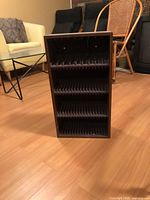 Front view showing five slotted shelves and dark brown veneer finish