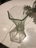 Full view of clear hexagonal bubble glass vase on table