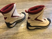 Side view of both boots showing uppers, sole, and branding