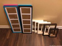 All seven picture frames standing against wall