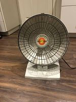 Front view of Presto HeatDish Plus heater on wood floor