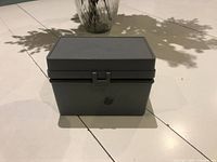 Front view of gray plastic storage box showing latch