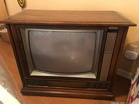 Front view of wood console CRT TV with screen and speakers