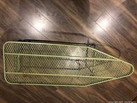 Top view of green steel mesh ironing board