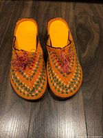 Top view of both shoes showing embroidered uppers and insoles