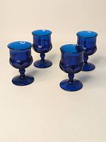 Group shot of four cobalt blue wine goblets