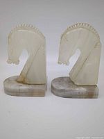 Front view of both stone horse head bookends