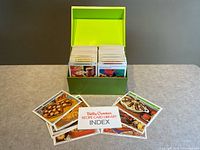 Full view of green box open with recipe cards and loose sample cards with index