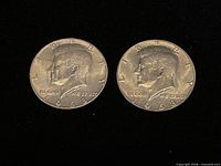 Two obverse sides of 1968 Kennedy half dollar coins