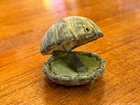 Closed clamshell box showing exterior texture and latch