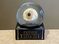 Front view of eyeball water globe on book base