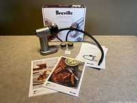 full set displayed: smoking gun, hose, two chip tins, manuals, box