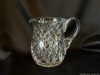 Front view of cut crystal pitcher showing diamond and crosshatch pattern