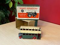 Box with lid, inner tray visible, bus positioned in front