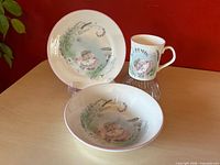 Full view of bowl, plate on stand and mug showing complete set and design