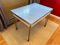 Full view of table showing blue laminate top and chrome legs