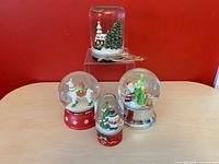 All four snow globes grouped
