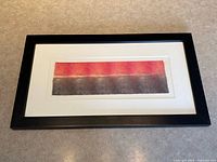 Full view of framed textile art showing frame, mat and artwork