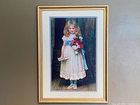 Full view of framed embroidered portrait on wall