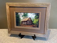 Framed photograph on easel showing full view with mat and frame