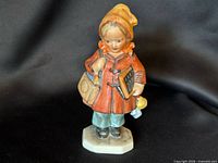 Full view of figurine front showing pose, attire, and base