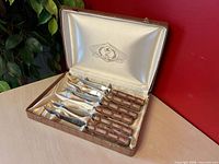 Open presentation case showing six steak knives