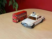 Jaguar police car front three-quarter with Londoner bus rear view