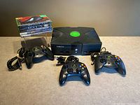 Console, three controllers, stacked games visible