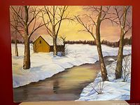Full view of oil painting with creek, snow, trees, barn, sunset