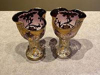 Pair of amethyst glass pedestal vases side by side top view